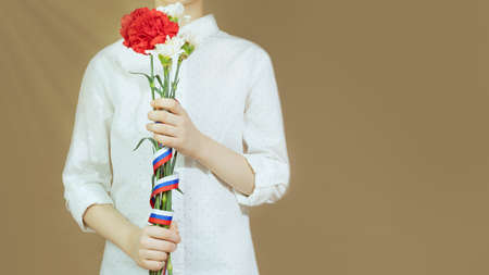 School boy with carnations with Russian flag ribbonの写真素材