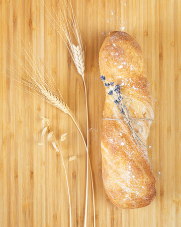Fresh crunchy french baguette, ears of rye and wheatの写真素材