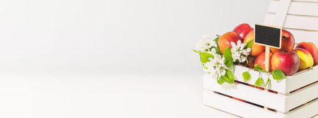 Selling seasonal, local fruits and vegetables. Natural, farm apples in a white wooden box with chalkboard on a white background with copy space. New crop. Banner size, soft focus style imageの写真素材