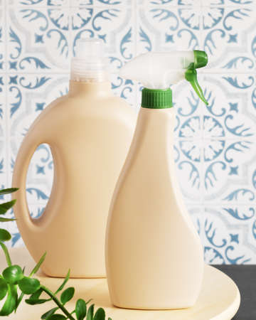 Mock up of natural, cleaning products. Two bottles of natural detergents for house cleaning on a wooden board in the kitchen. Eco friendly cleaning. vertical orientation. soft focus styleの写真素材