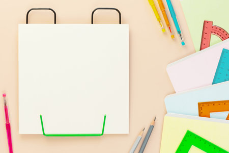 Back to school background with multicolored notebooks, pens, rulers and empty white sheet of paper....