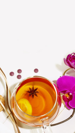 Home relaxing concept. Wooden tray with cup of fruit tea with lemon slice, aroma sticks and orchids on white background with copy space. Concept of Me time and no depression. Remedy for healthy sleepの写真素材