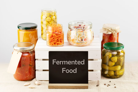 Seasonal pickled or fermented vegetables and mushrooms in a glass jars