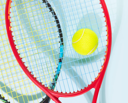 Tennis competition card. Sport composition with yellow tennis ball and tennis rackets on a blue background.Tennis game. Sport and healthy lifestyleの写真素材