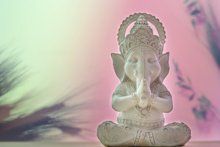 Sculpture of Lord Ganesha on a gradient background with shadows and copy space. Holiday of Ganesh Chaturthi. Ganesh festival. Hindu religion holidays. Front viewの写真素材