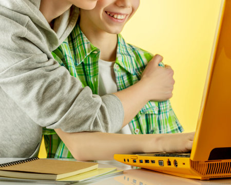 Mother with son making video call, looking at laptop screen
