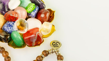 Crystals gemstones set with rosary beads on white background. Minerals for esoteric spiritual practice, Healing Crystal Ritual, Witchcraft, Relax Chakra. Reiki therapy, meditation concept. Copy spaceの写真素材