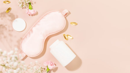 Self care flat lay with mask for sleep, sleeping gel capsules or vitamins or dietary supplements and flowers. Concept of healthy sleep and no depression. Natural remedies for relax. Copy spaceの写真素材