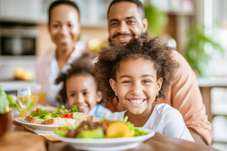 Smiling, multicultural family enjoys a home-cooked meal together, reflecting the rich tapestry of shared traditions and the joyous bond of kinship, diversity, and the love that binds themの素材