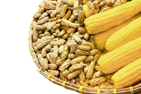 Isolated wicker basket with fresh corn cobs and raw peanuts, showcasing agricultural abundance and...