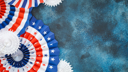 Patriotic Paper Fans In Red White Blue On Textured Blue Background For 4th Of July Celebration. Concept Of American Holiday Decor, Festive Layouts, And Seasonal Visuals For Social Mediaの写真素材