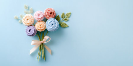 Crochet Flower Bouquet With Ribbon On Pastel Blue Background With Copy Space. Concept Of Handmade Gift, DIY Floral Decoration, Mother's Day Greeting, Craft Project Idea, And Holiday Backgroundsの素材