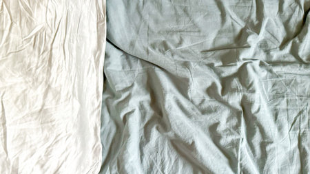 Unmade Bed With Wrinkled Sheets In Morning Light For Concepts Of Daily Routine, Restful Sleep, Home Comfort, Slow Living Aesthetics, And Minimalist Visuals Focused On Authentic Everyday Momentsの写真素材