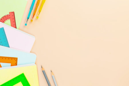 Back to school background with multicolored notebooks, pens and rulers. School supplies on a ivory background with copy space. School sale concept. Flat layの写真素材