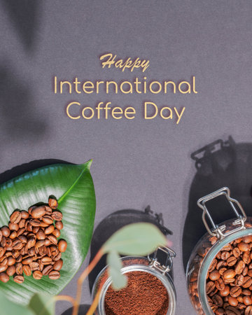 International coffee day card with organic roasted coffee beans on a green leaves and coffee powder in a glass jar on a black background with congratulations textの写真素材
