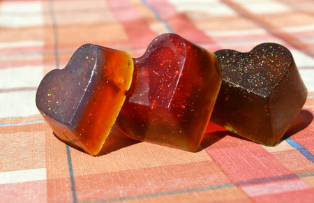 Orange, red and brown handmade soaps in heart shapeの写真素材