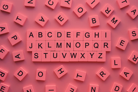 ABC blocks with letters on pink background. Back to school concept.の写真素材