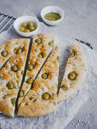 Traditional Italian focaccia bread with olives, rosemary, salt and olive oil. Homemade focaccia.の写真素材