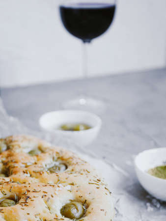 Traditional Italian focaccia bread with olives, rosemary, salt and olive oil. Homemade focaccia.の写真素材
