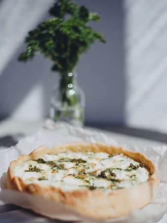Quiche homemade pie with fresh herbs and feta cheese.の写真素材