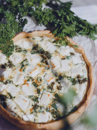 Quiche homemade pie with fresh herbs and feta cheese.の写真素材