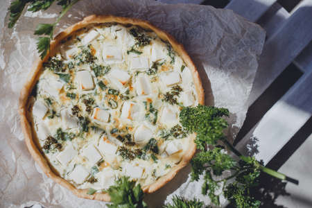 Quiche homemade pie with fresh herbs and feta cheese.の写真素材