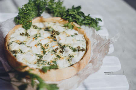 Quiche homemade pie with fresh herbs and feta cheese.の写真素材