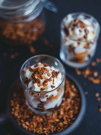 Organic homemade granola Ñereal with oats and walnuts, with ice cream and apricots. Healthy snack.の写真素材