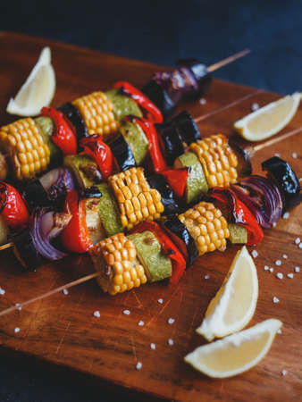 Skewers of grilled vegetables, corn, zucchini, eggplant, champignons, red pepper and onions.の写真素材