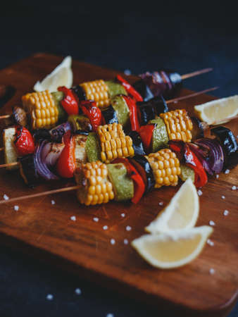 Skewers of grilled vegetables, corn, zucchini, eggplant, champignons, red pepper and onions.の写真素材