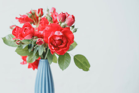Bouquet of red roses in a blue vaseの写真素材