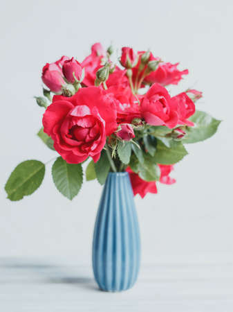 Bouquet of red roses in a blue vaseの写真素材