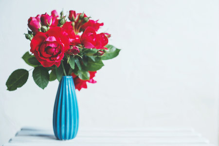 Bouquet of red roses in a blue vaseの写真素材