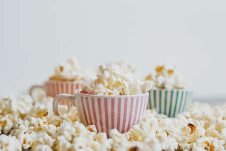 Salted popcorn in multi-colored cupsの写真素材