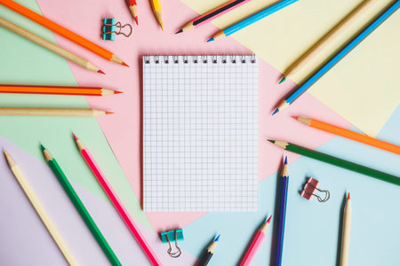 School notebook and pencils, on a multicolored background. Education concept. Back to school.の写真素材