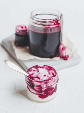 Greek yogurt or cottage cheese with homemade blackcurrant jam.の写真素材