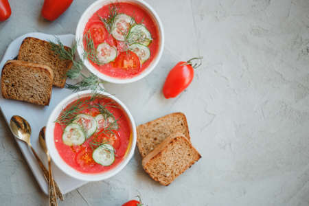 Cold soup gazpacho, made from tomatoes, paprika, cucumber, onion and garlic, with toasted bread slices.の写真素材