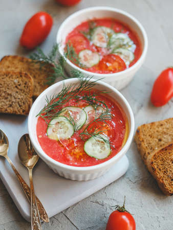 Cold soup gazpacho, made from tomatoes, paprika, cucumber, onion and garlic, with toasted bread slices.の写真素材