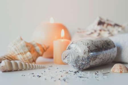 Natural sea salt with lavender and candles. Health care spa therapy concept and wellness. Spa still life.の写真素材