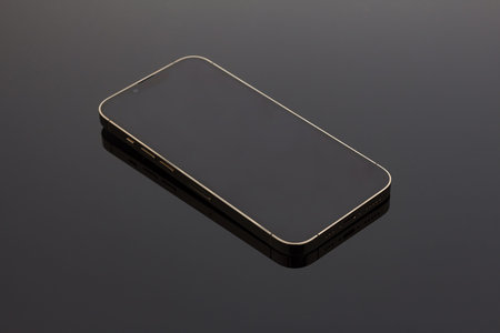 A closeup shot of a black smartphone on a black background. Close up photo of modern smartphone's...