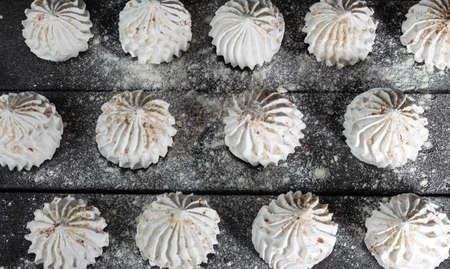 Still life in style of food. Culinary background with meringue on dark wooden background.の写真素材
