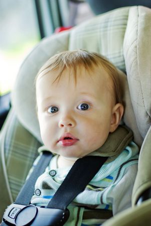baby in the safety chair in the carの写真素材