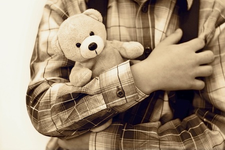 Safety concept. The boy is holding teddy bearの写真素材