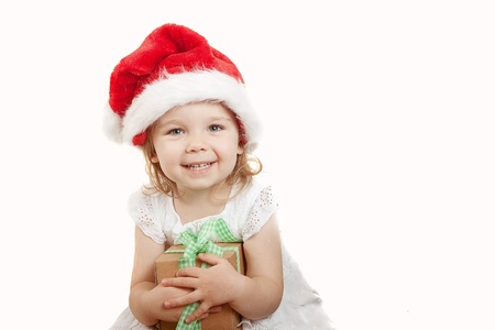 little girl with Christmas cap and a presentの写真素材