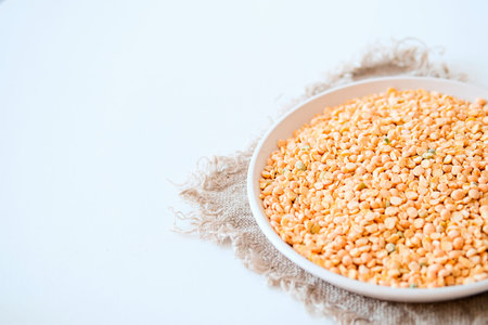 Dry split peas on a beige napkin on a light background. copyspace.