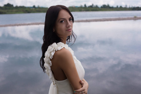 Beautiful sexy woman in a wedding-dress in cold waterの写真素材
