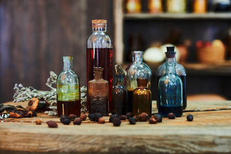 old wooden table, dried herbs, bottles, a top view, in the studio, in the afternoon.の写真素材