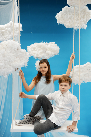 boy in white shirt swinging on a swing in heaven. angel Paradiseの写真素材