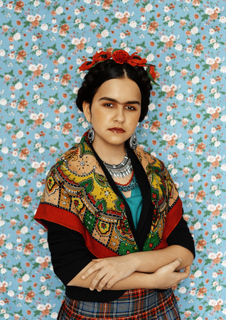 girl in Indian clothes posing on a background of flowersの写真素材