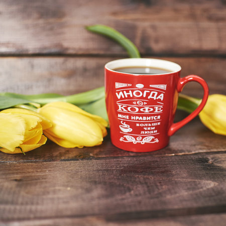 A Cup of coffee with the inscription Sometimes I like coffee more than people on a wooden background...